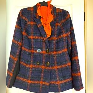 Double-breasted wool blazer in warm hues and generous cut.